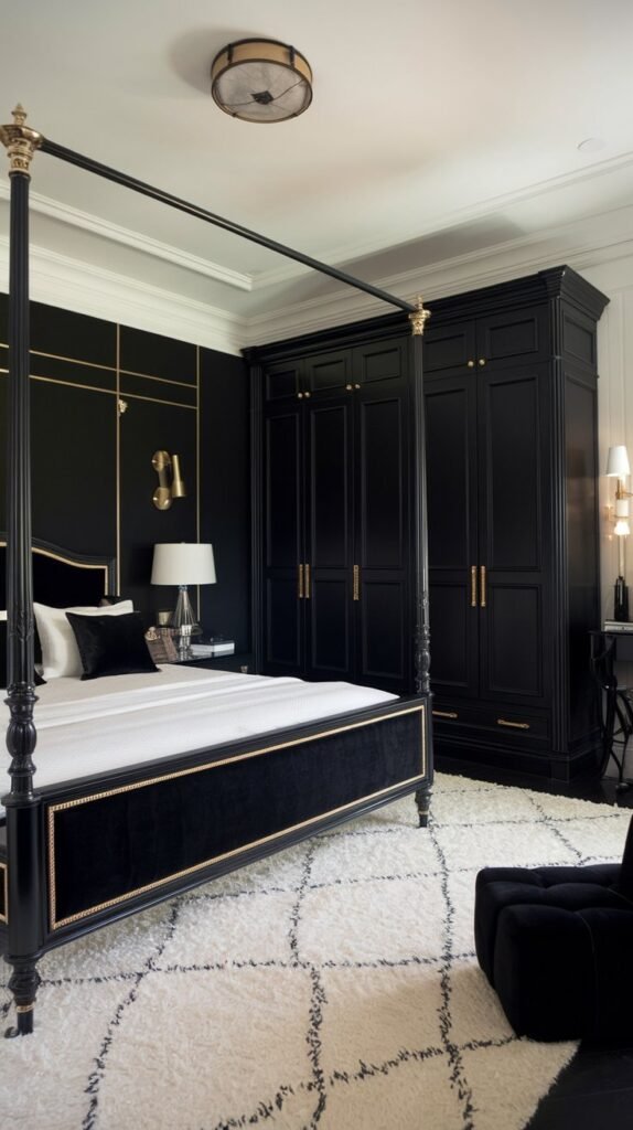 A bedroom with a black accent wall. The room has a king-size bed with a black frame and a white mattress. There is a black wardrobe with gold handles and a white lampshade on the bedside table. The room has a white rug and a black chair in the corner. The ceiling has a recessed light fixture.