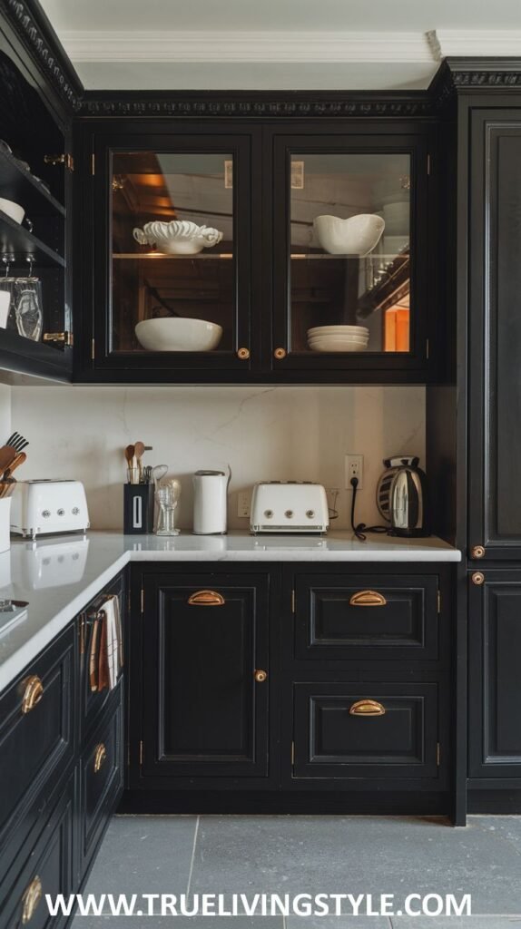 A close-up of a kitchen corner with black cabinets, white countertops, and small appliances.