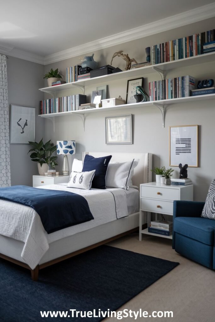 Navy and white bedroom with open shelves displaying books and plants.