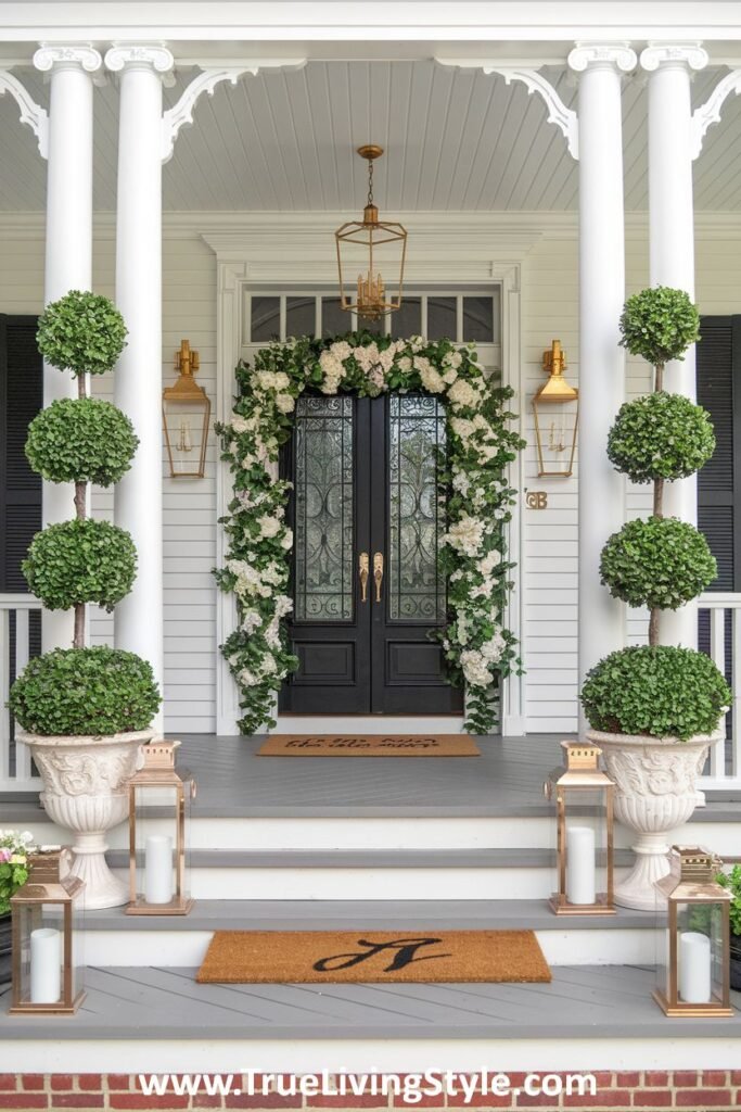 A grand entrance with a floral archway, topiaries, and classic lanterns.