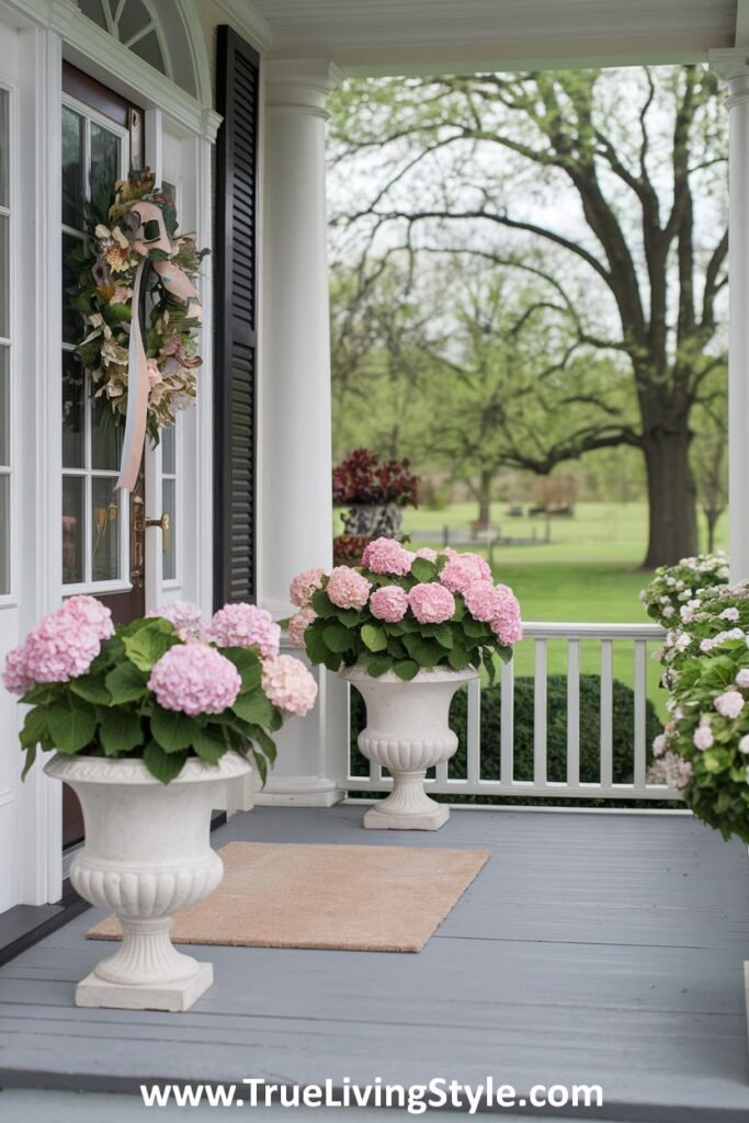 A timeless front porch with classic urn planters filled with greenery.