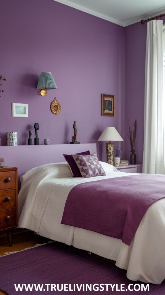 A regal bedroom with purple walls and white trim. A bed with white bedding and a purple throw is featured, along with a dark wooden dresser.