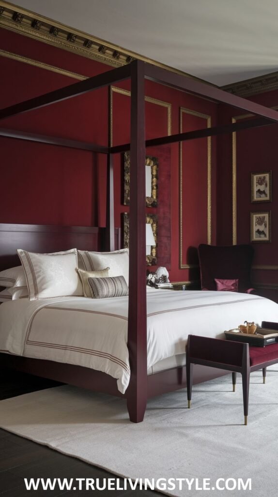 A minimalist dark red bedroom creates a sophisticated space with dark red walls and a sleek, modern four-poster bed. The bedding is simple and elegant in light colors contrasting the deep walls, and a light-colored rug covers the floor. Minimal decor maintains a clean aesthetic.