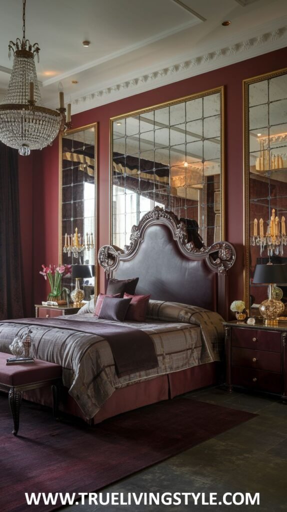A glamorous dark red bedroom is designed with large mirrored panels on the walls to create a sense of spaciousness and reflect light from the elegant crystal chandelier. Luxurious bedding with metallic accents and rich textures adorns the bed, and sleek, dark bedside tables are present.