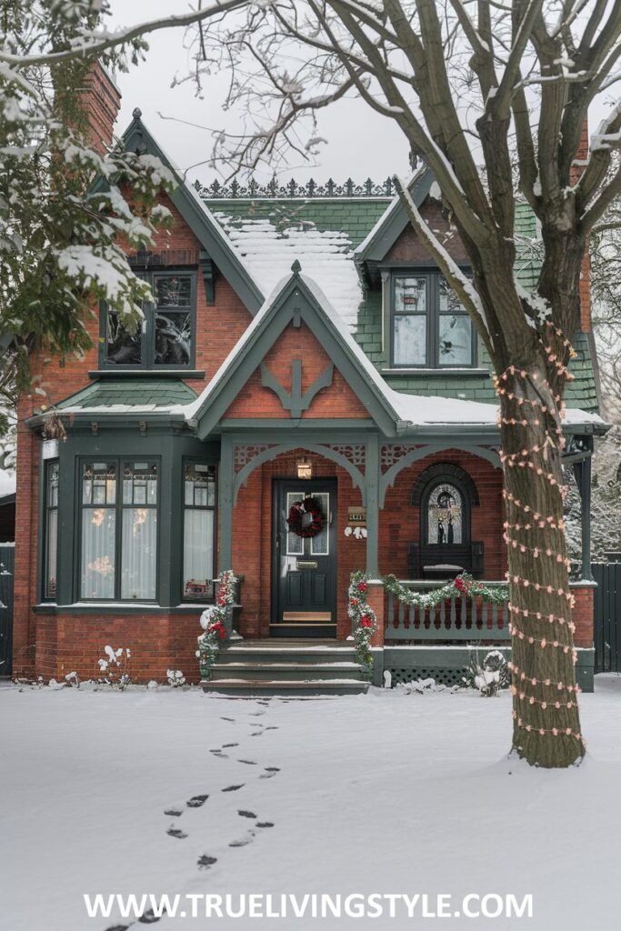 A festive red brick Victorian cottage decorated for the holidays.