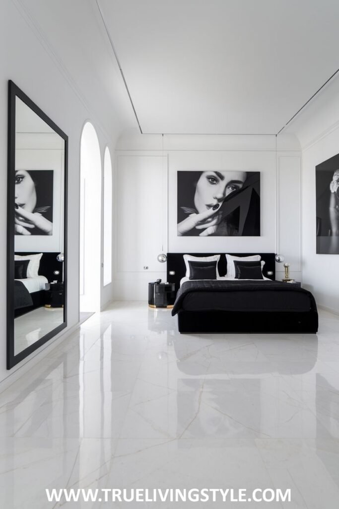 A large mirror amplifies light and space in a bedroom with black bedding and furniture.