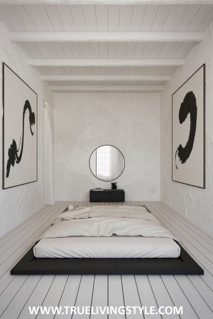 Black and white art hangs on the wall, paired with a floor bed and minimalist decor.