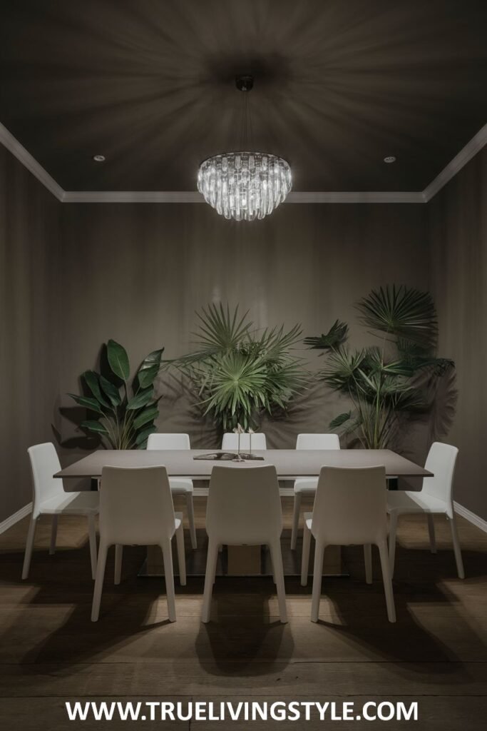 A moody elegance minimalist dining room with dark walls, a crystal chandelier, a simple light table, and white chairs.