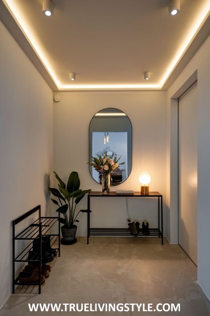 A hallway featuring a mirror, console table with decorations, a shoe rack, and ceiling lights.