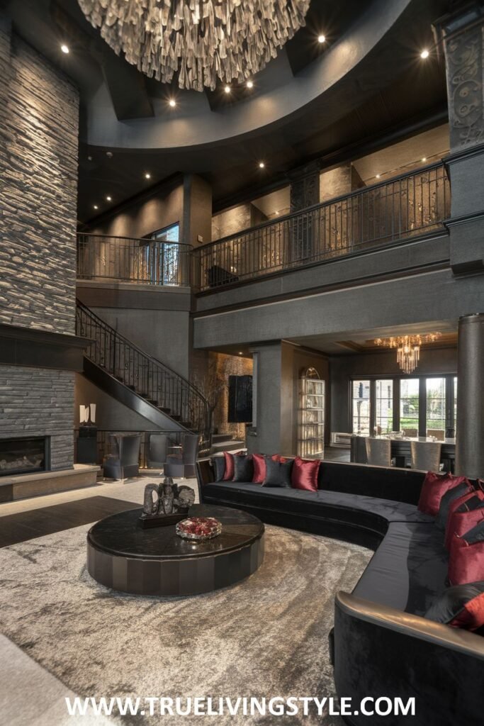 Dramatic dark wood living room in a mansion with a stone fireplace, a second-floor gallery, and a curved black sectional sofa with red accents.