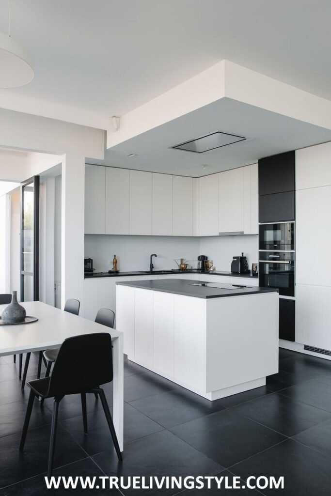 An open-concept kitchen with a white island and a dining area.