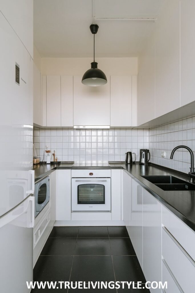 A kitchen with black countertops and a black backsplash.