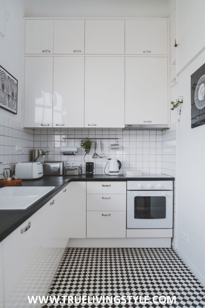 A kitchen with black and white checkered flooring.