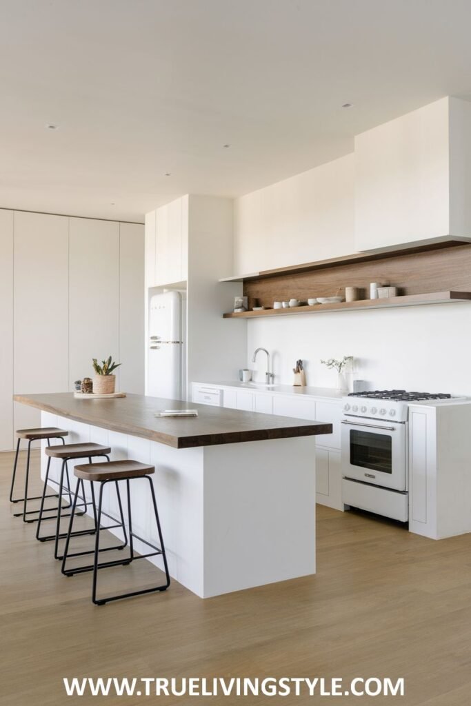 A kitchen with an expansive island and barstool seating.