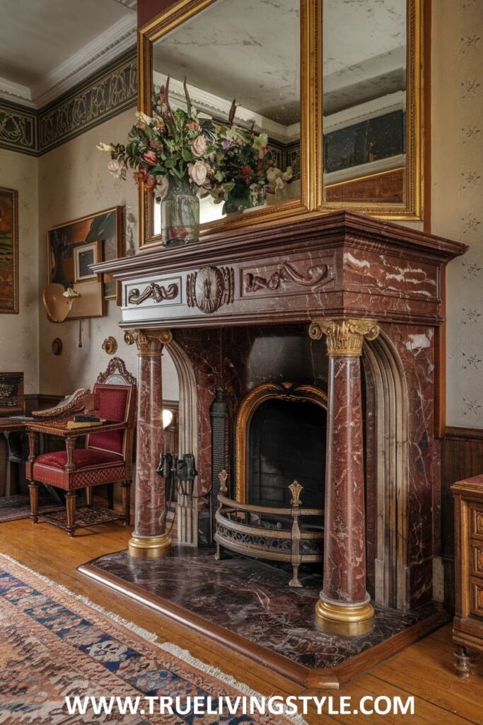 A luxurious victorian fireplace constructed from rich red marble with gilded Corinthian columns.